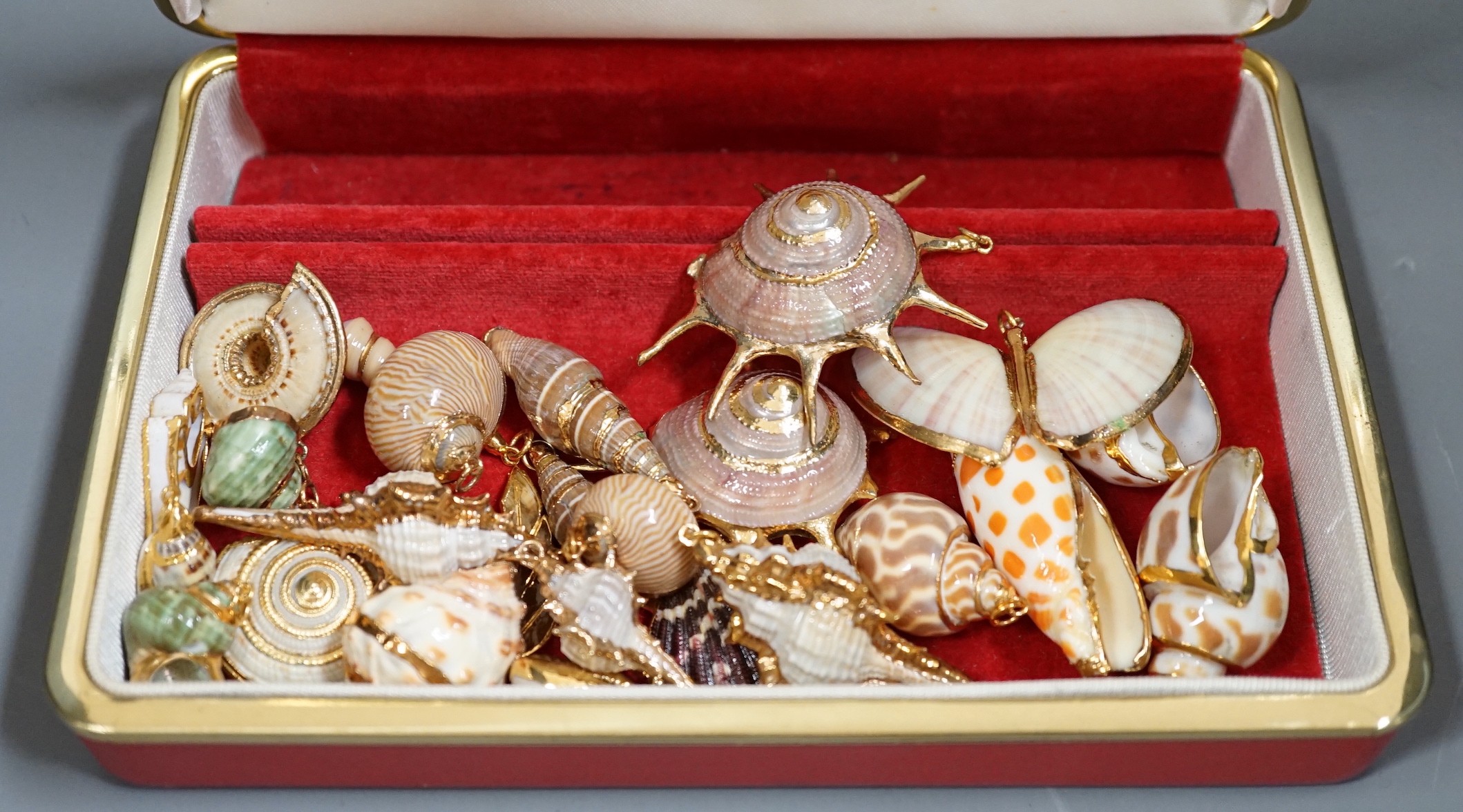 A small group of assorted gilt mounted sea shell pendants. largest 69mm.